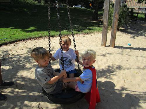 Children playing on swing.